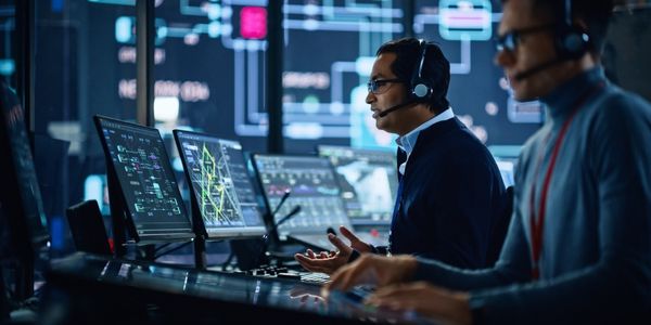 two men monitoring computers