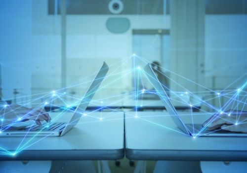 laptops open on a desks back to back