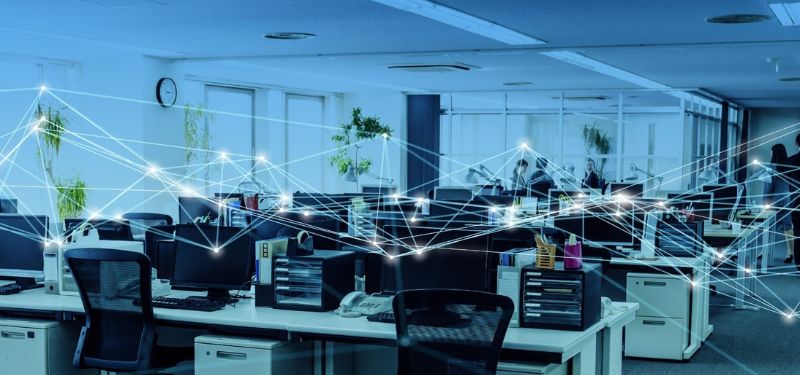 1st February TCI Blog – Evaluating Your Network Infrastructure Recognizing Trouble Signs – feature – final an empty office with a graphic depicting how all the desktop computers are connected