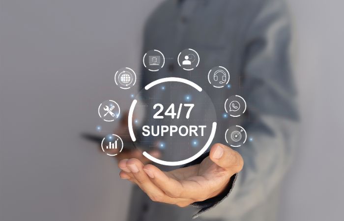 a male hand with a graphic image of a 24/7 support icon