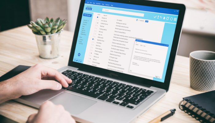 open laptop with list of email in an inbox