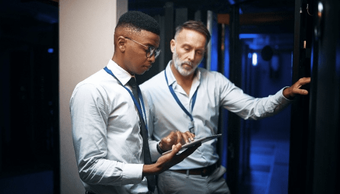 Two IT workers in a server room